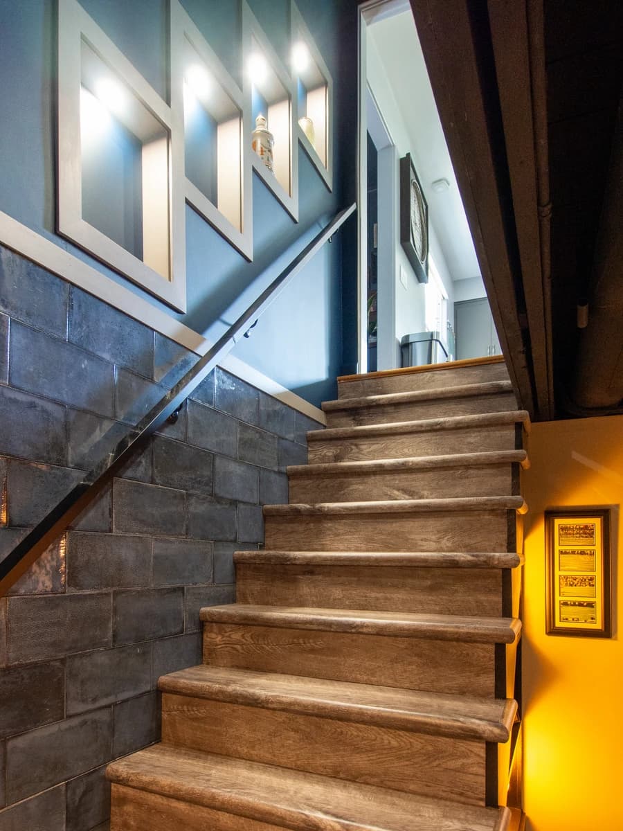 Stylish black and white stairwell with light wood flooring.