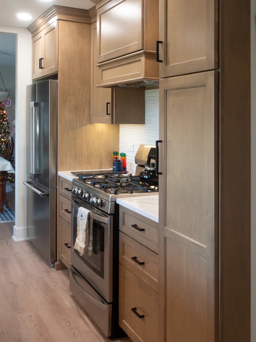 Brown kitchen cabinets and appliances, with a clean, modern design.