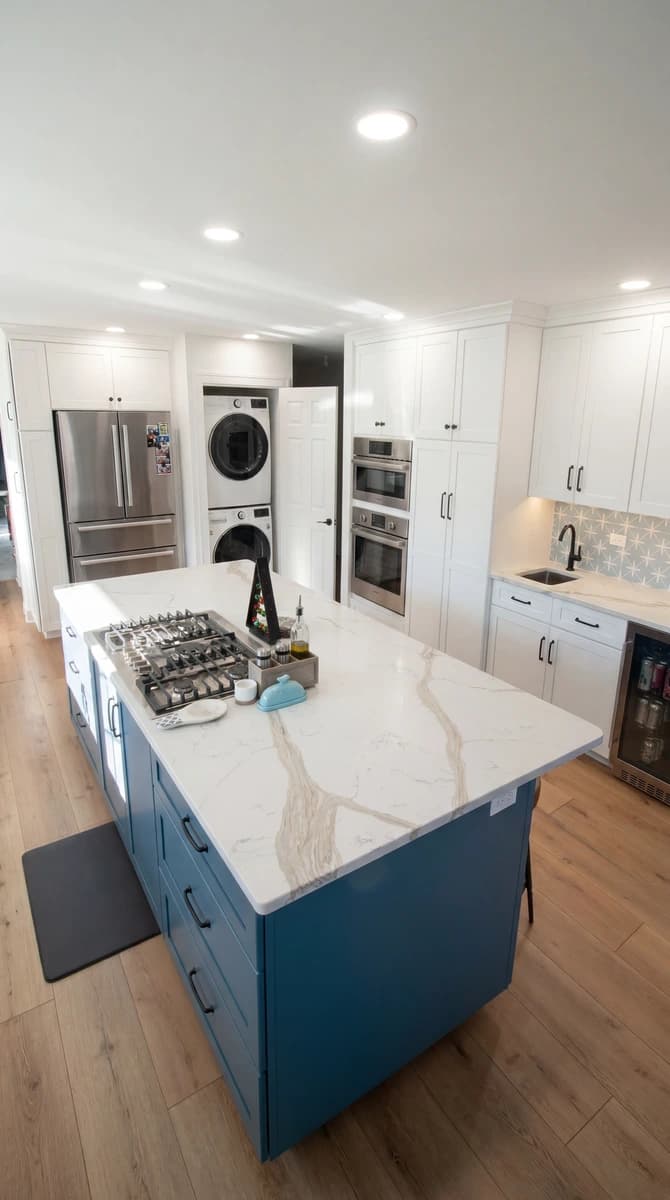 Kitchen with a modern island, blue cabinets, and white appliances.