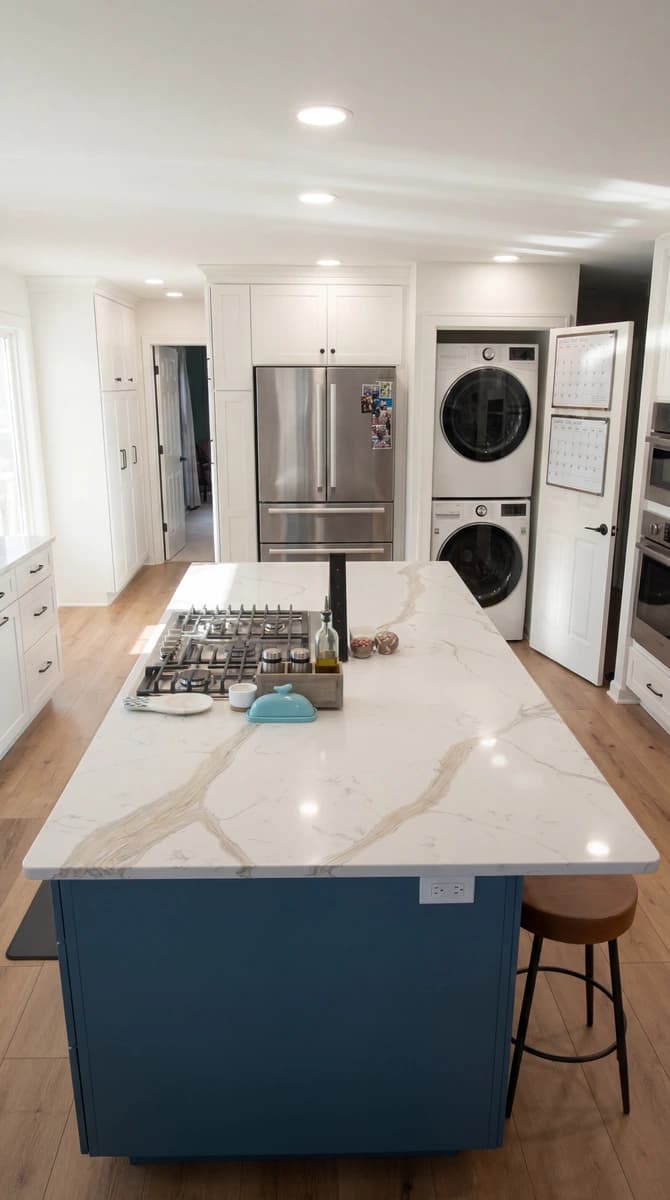 Large kitchen with granite counters, white cabinets, stainless steel appliances, and hardwood floor.