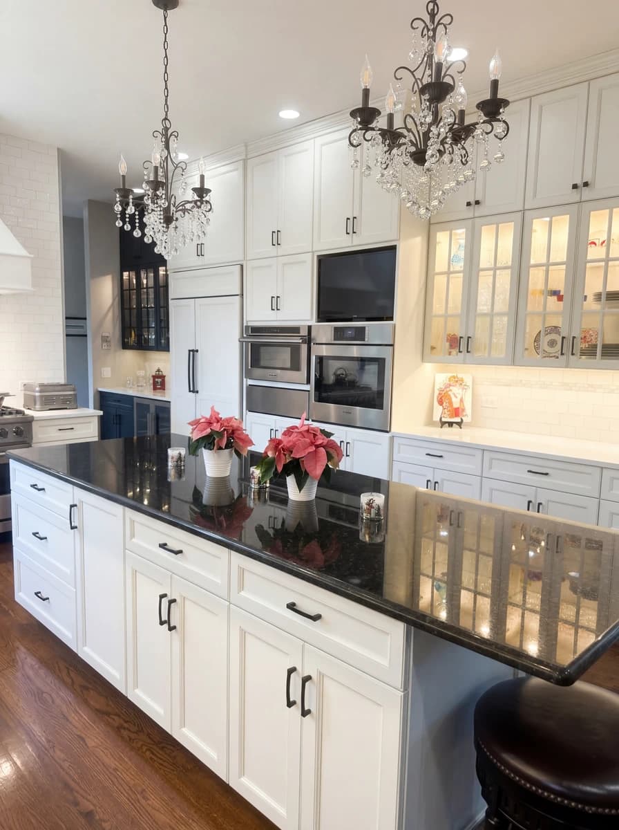 Modern kitchen with black countertops and white cabinets.