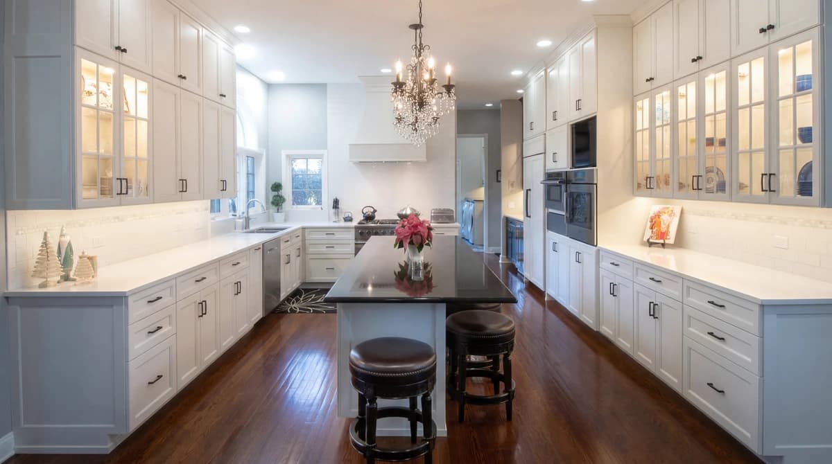 Large kitchen with white cabinetry, gray counters, and stainless steel appliances.