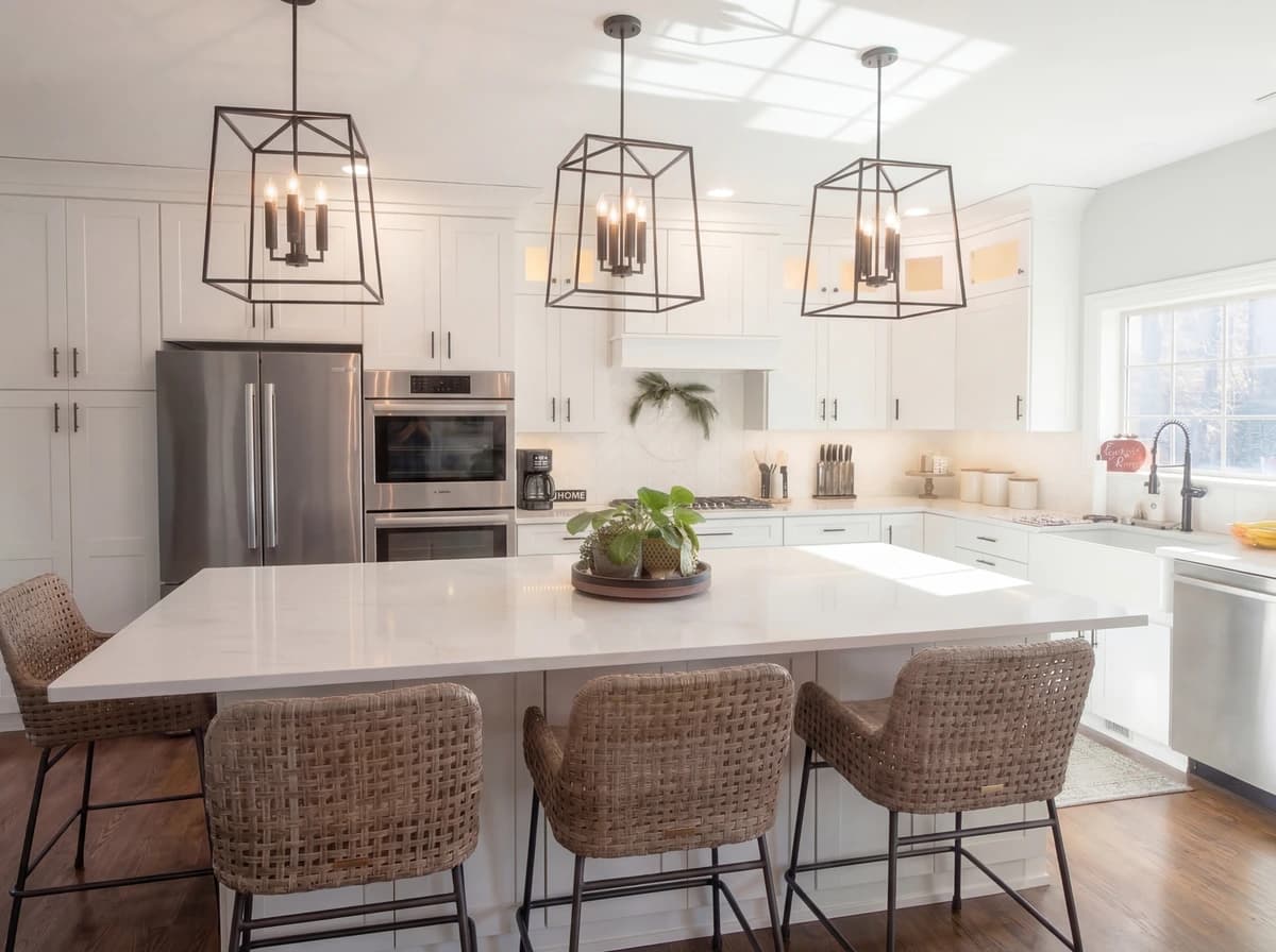 Modern kitchen with white cabinets, marble countertops, and white island.