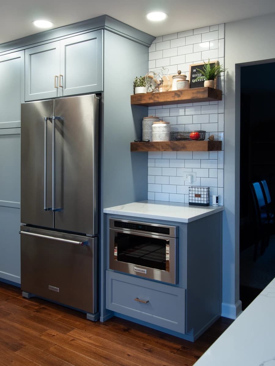 Grey kitchen cabinets and stainless steel appliances.