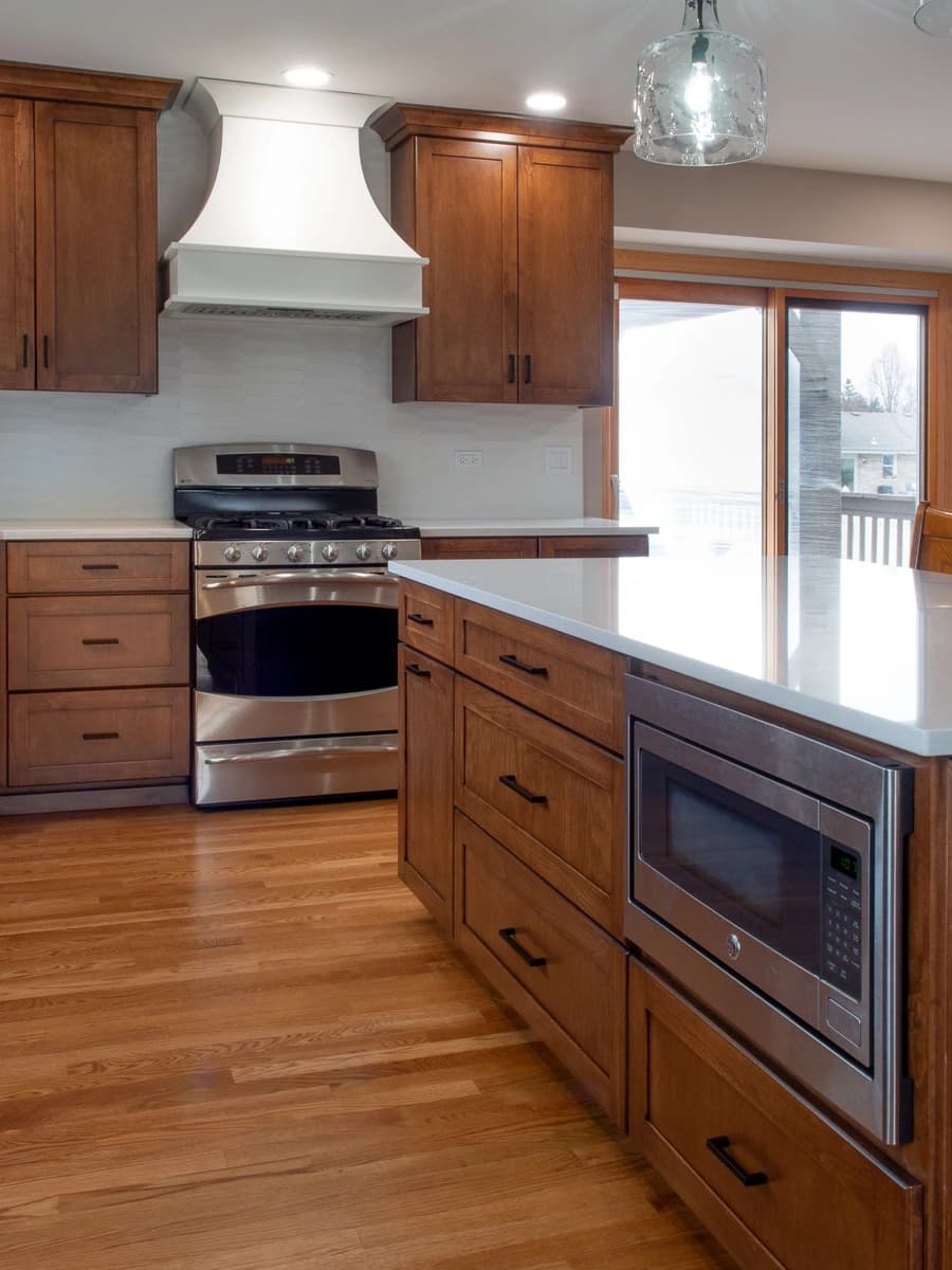 Modern kitchen with wood cabinets, stainless steel appliances, and granite countertops.