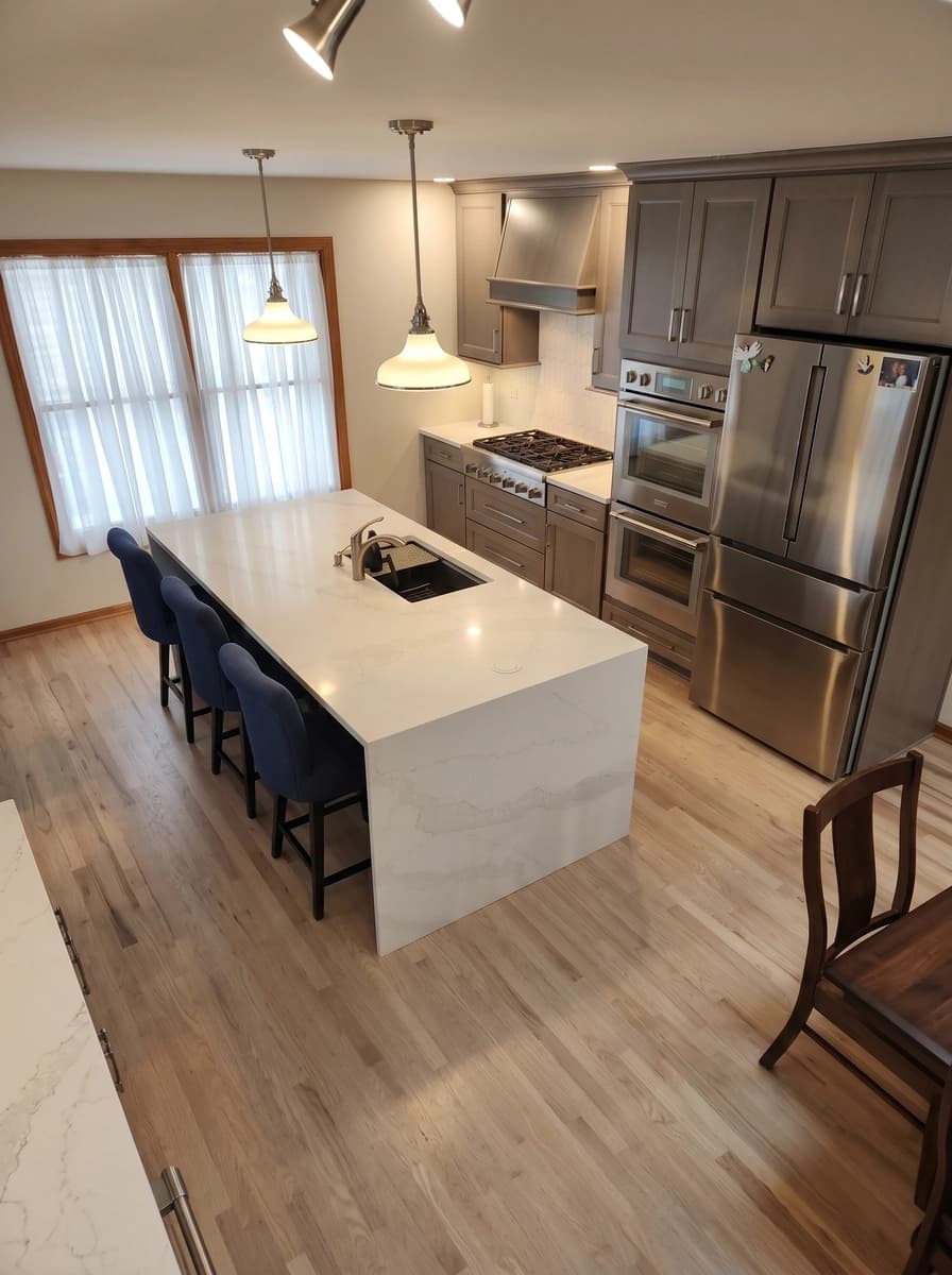 Clean modern kitchen with granite countertops, stainless steel appliances, dark cabinetry, wood