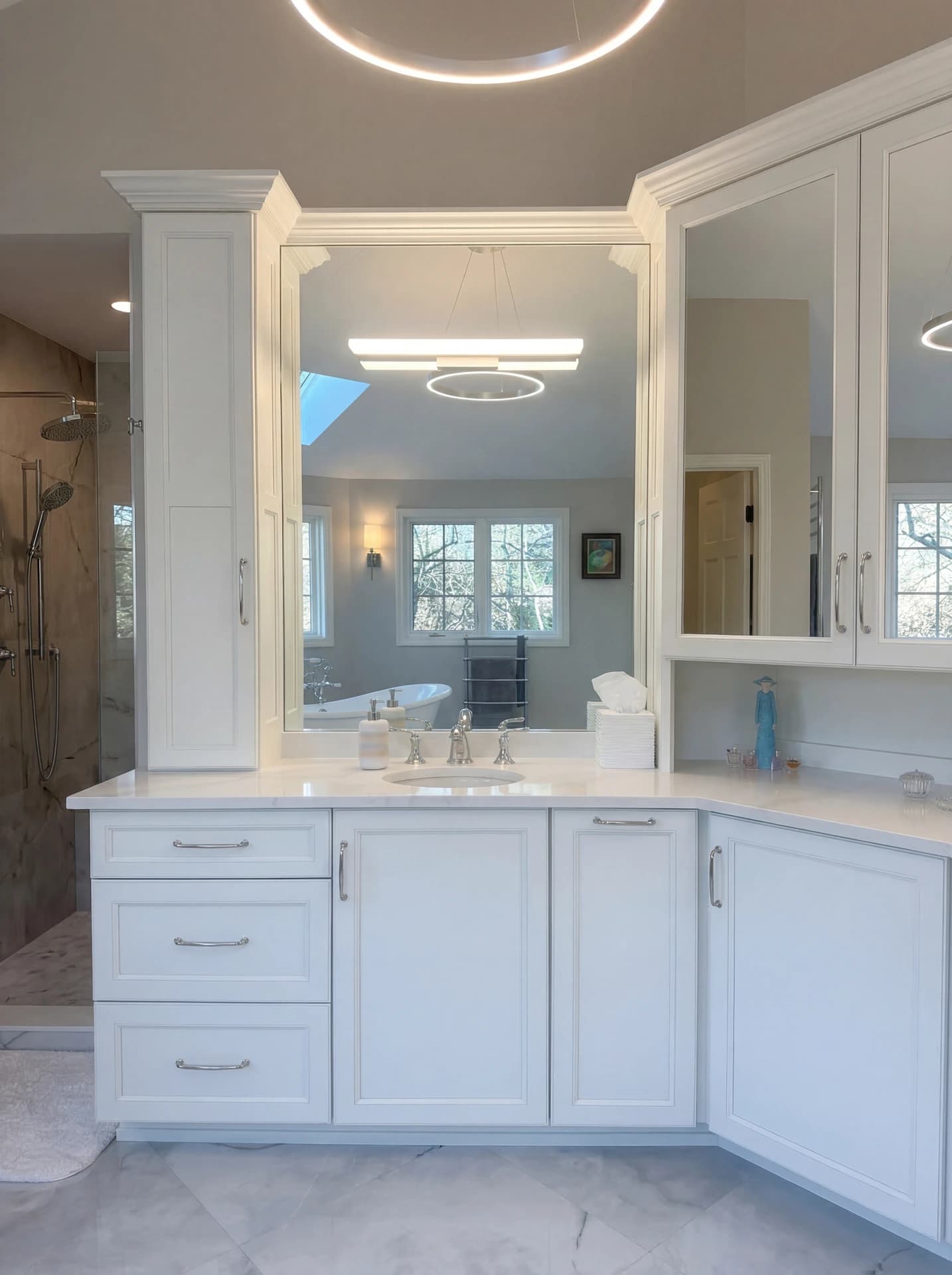 "Large, modern bathroom with clean, white cabinets, a double vanity, and a large mirror."