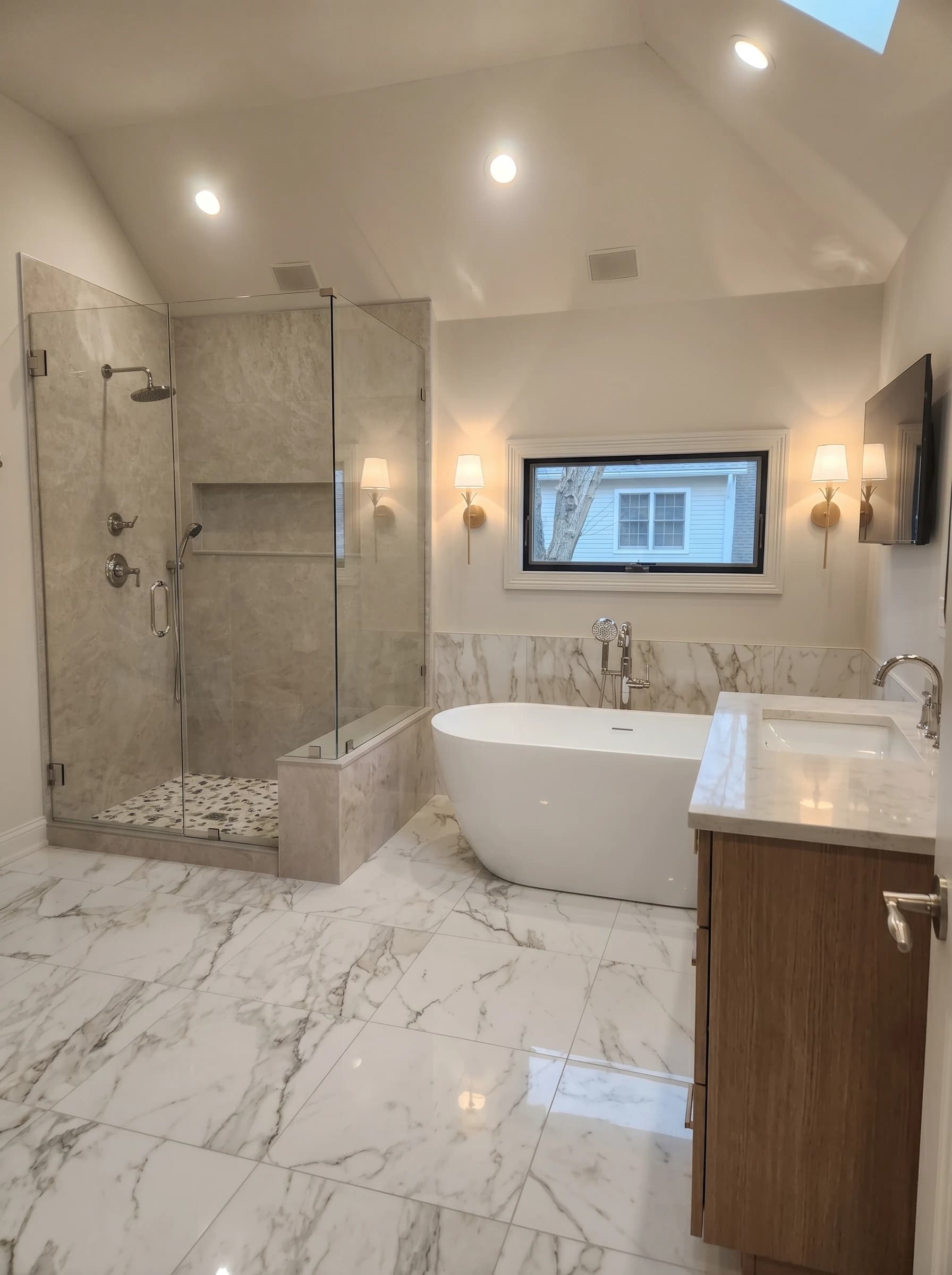 Luxurious marble bathroom with modern fixtures & neutral tones.