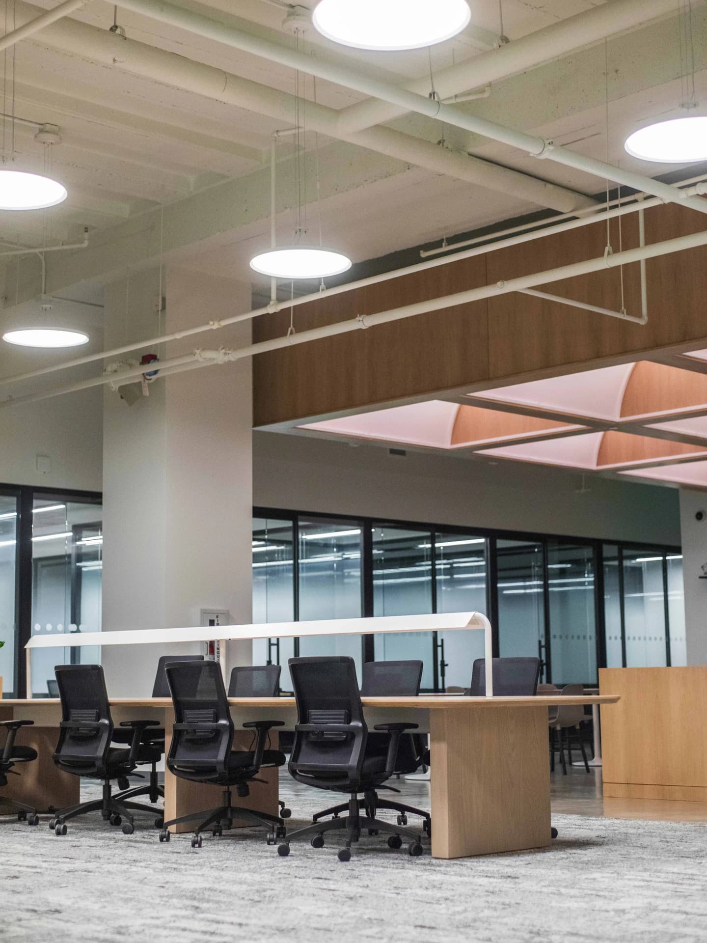 Open-concept lobby with modern furniture and industrial fixtures.
