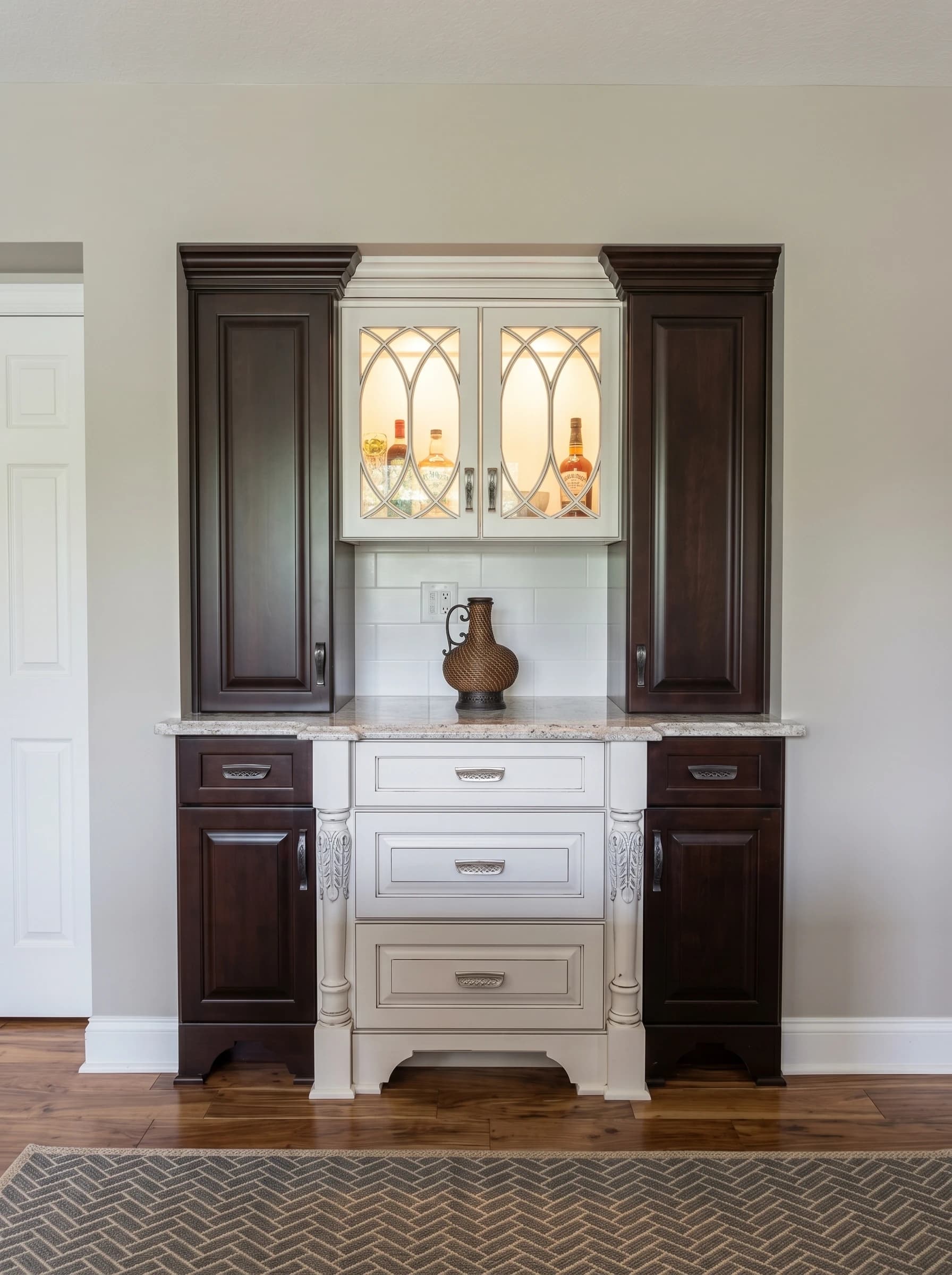 An elegant kitchen cabinet with white marble countertops and dark wood cabinets.