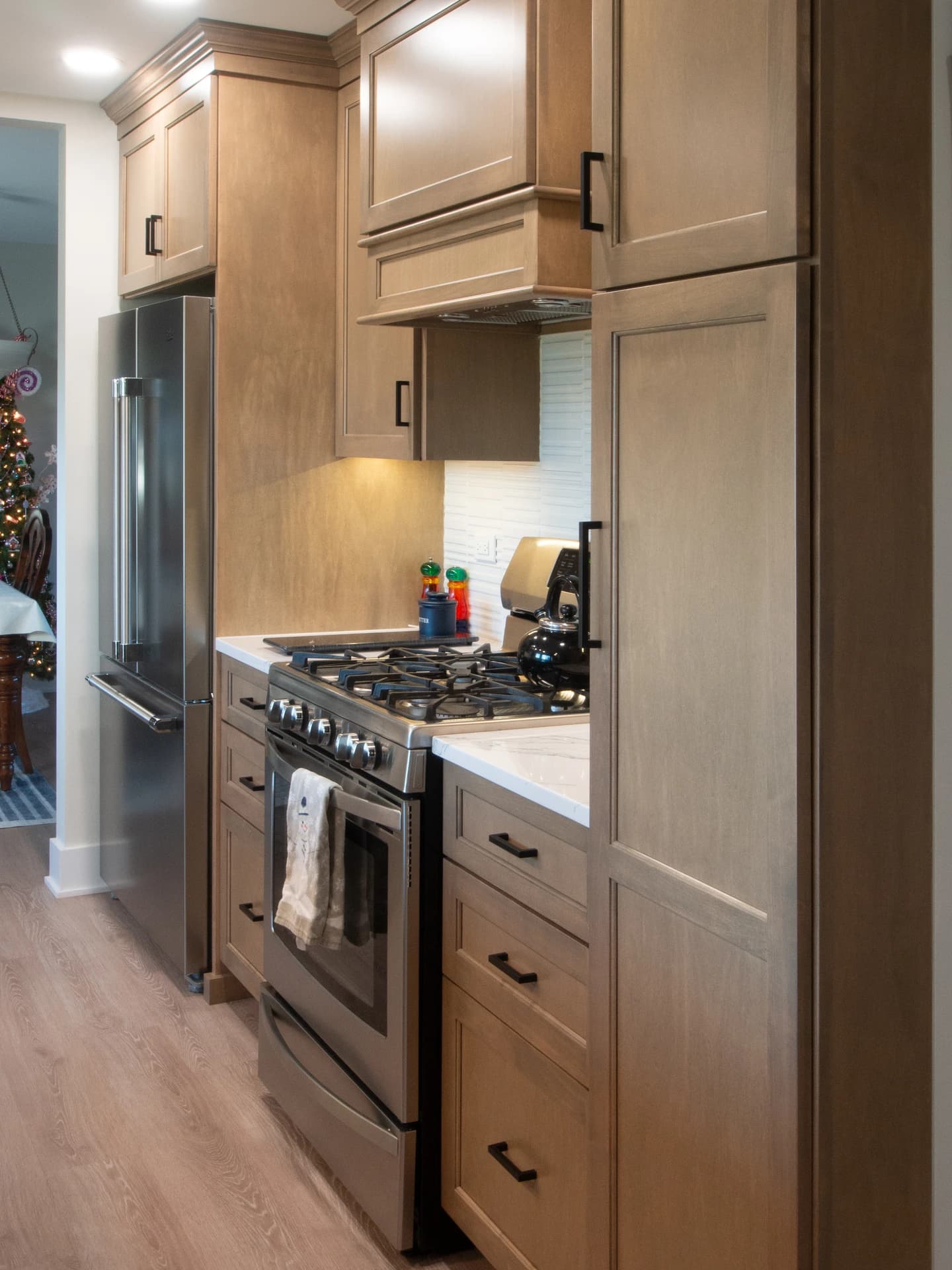 Brown kitchen cabinets and appliances, with a clean, modern design.