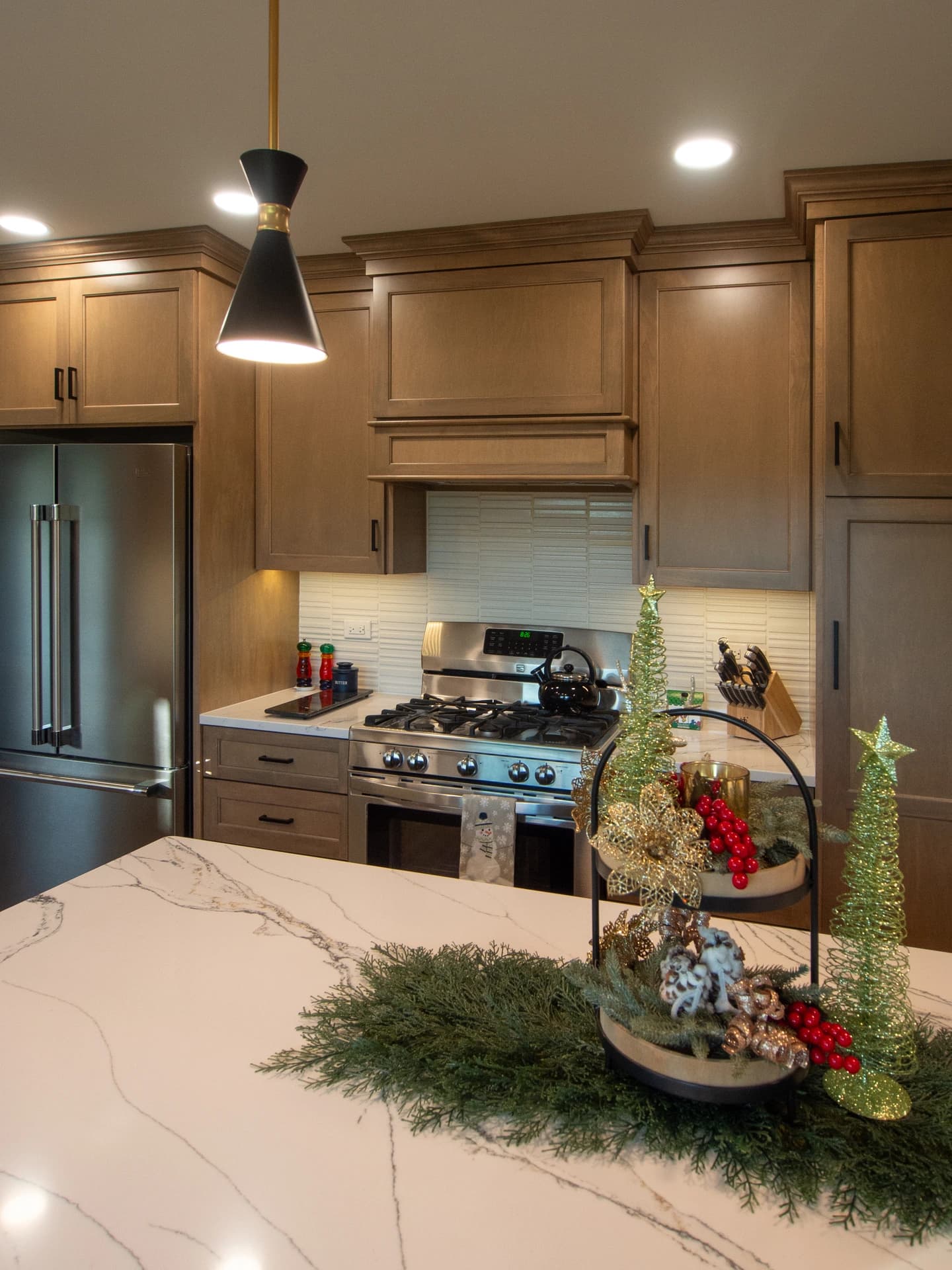 Kitchen cabinets are dark wood, modern design, granite countertops.