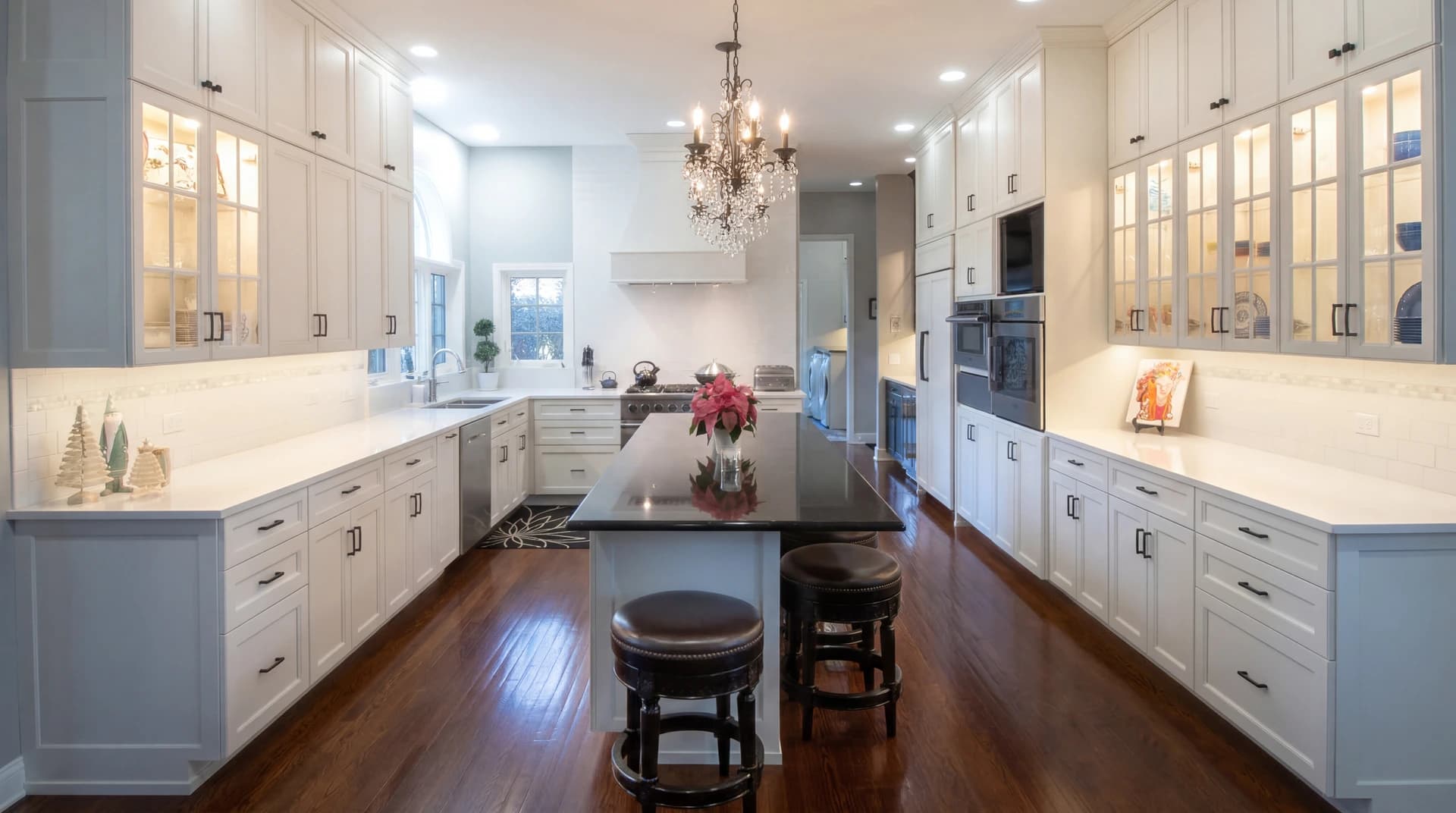 Large kitchen with white cabinetry, gray counters, and stainless steel appliances.