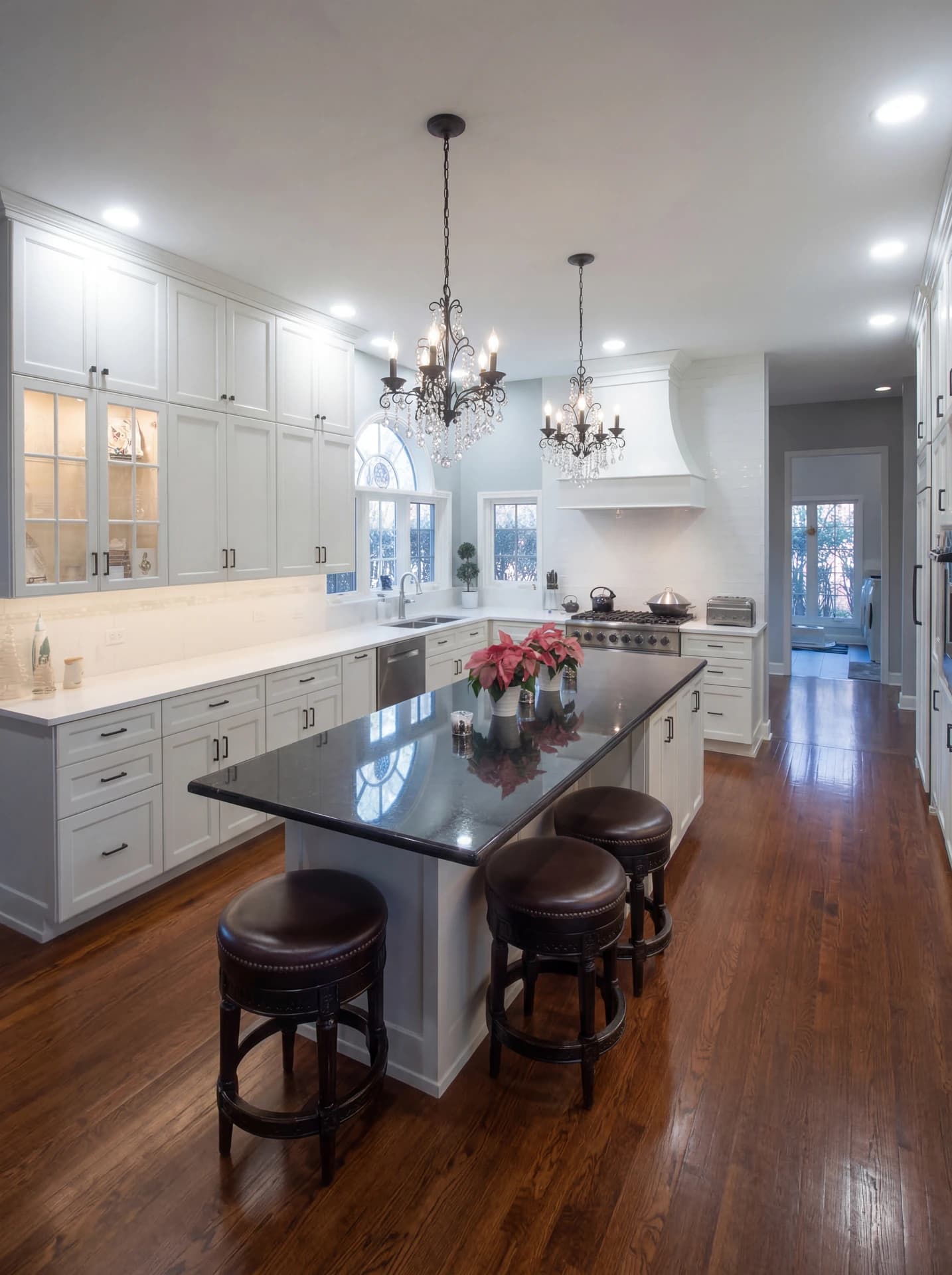 Modern kitchen with large island, high-end appliances, marble countertops and backsplash.