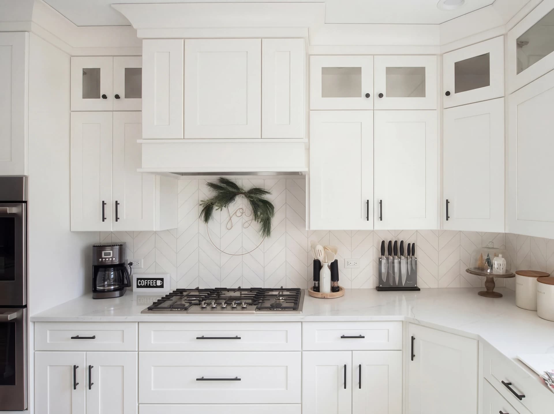 Bright, modern kitchen with white cabinets, a large island and stainless steel appliances.