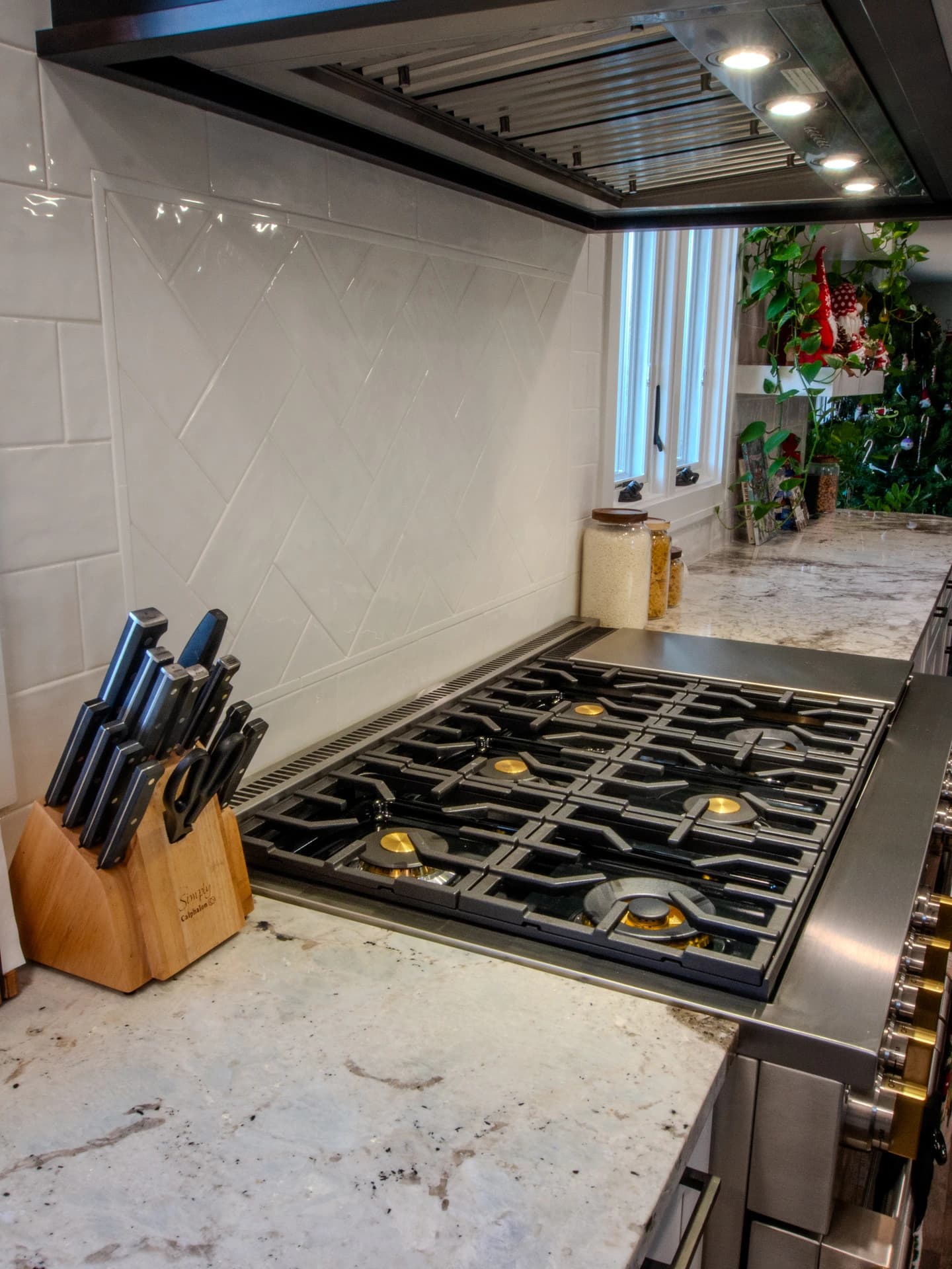 Stainless steel kitchen island with gas stove.