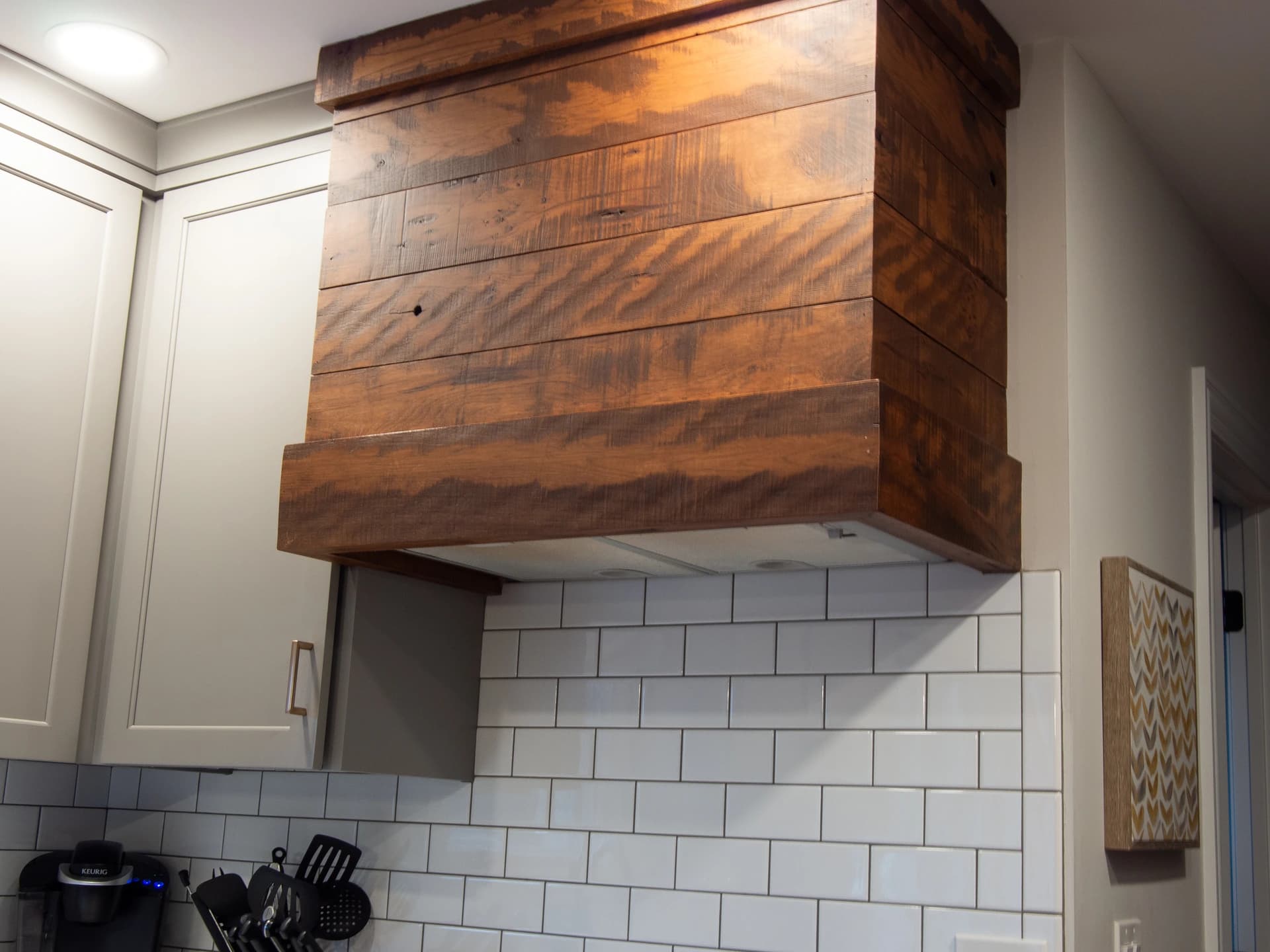 This is a home remodeling image featuring a large, rustic-style wooden kitchen island.