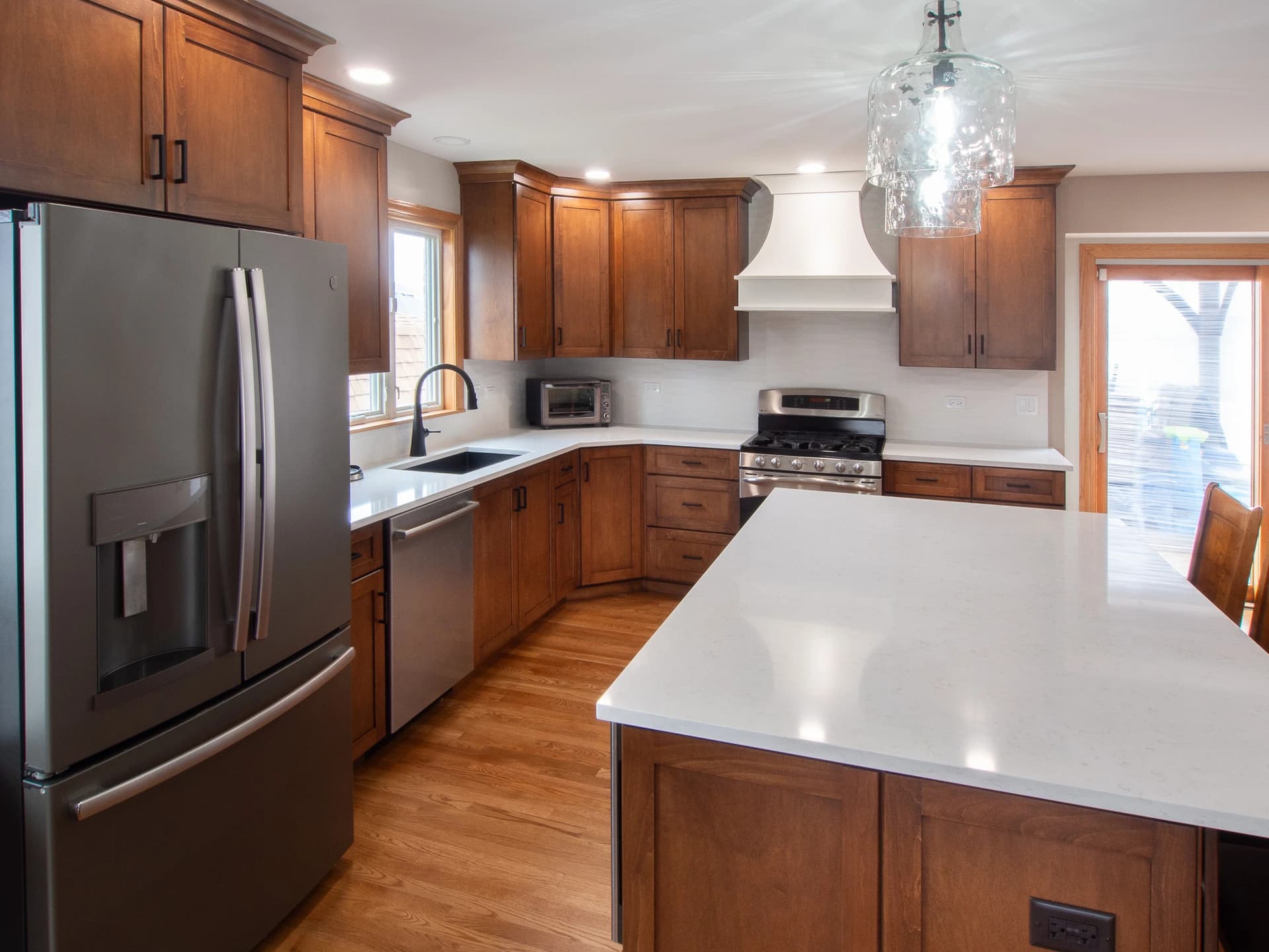 Modern kitchen with granite countertops and wood cabinets.