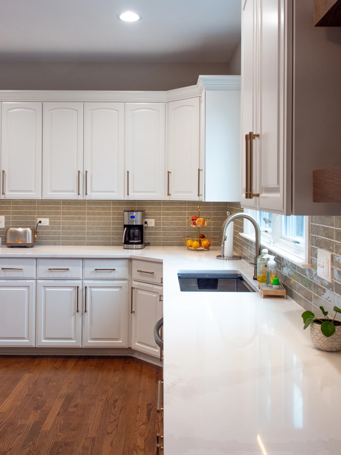 Kitchen remodel with white cabinets, granite counters, and modern appliances.