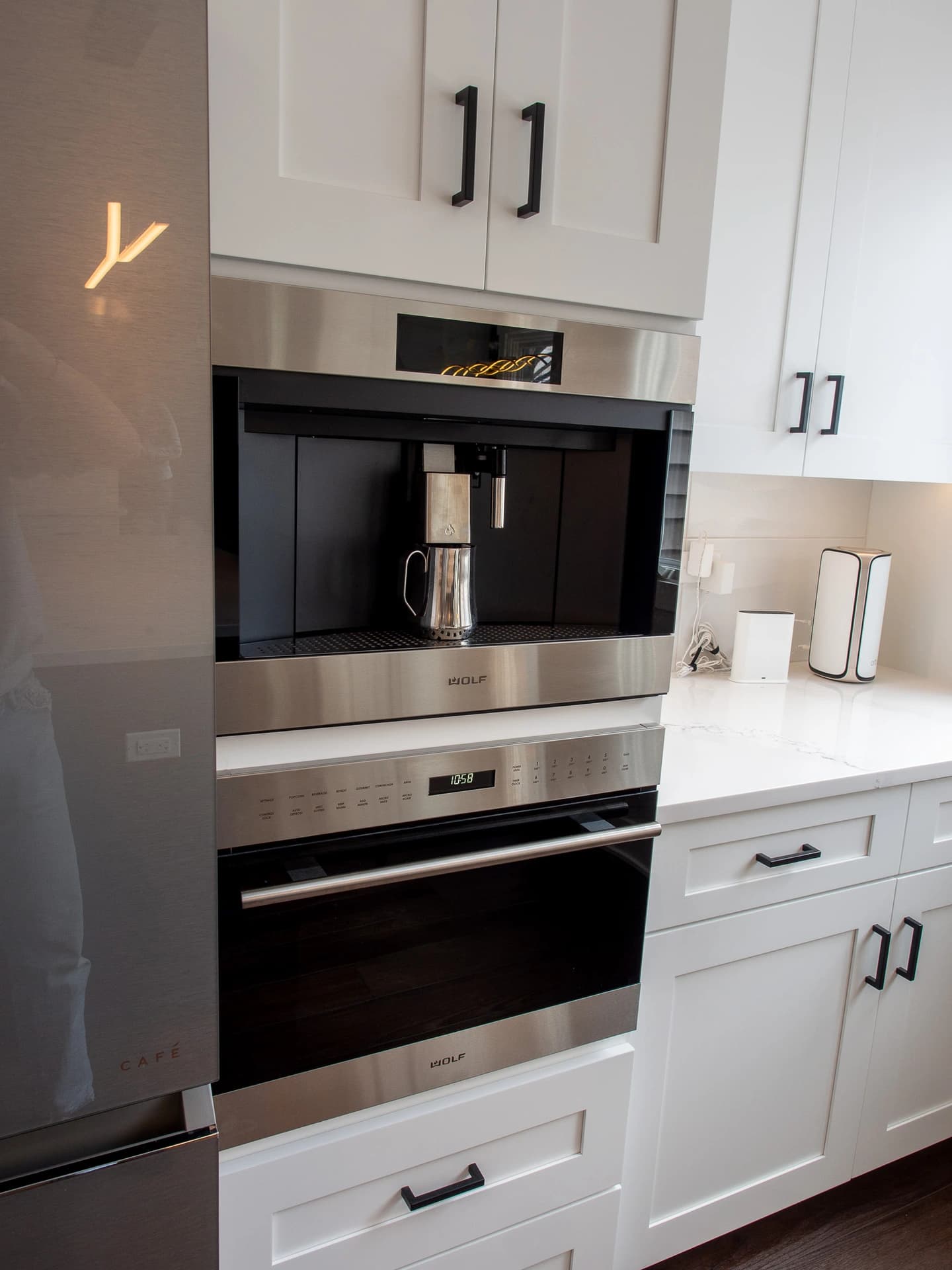 Stainless steel oven set in kitchen island, next to modern cabinetry.