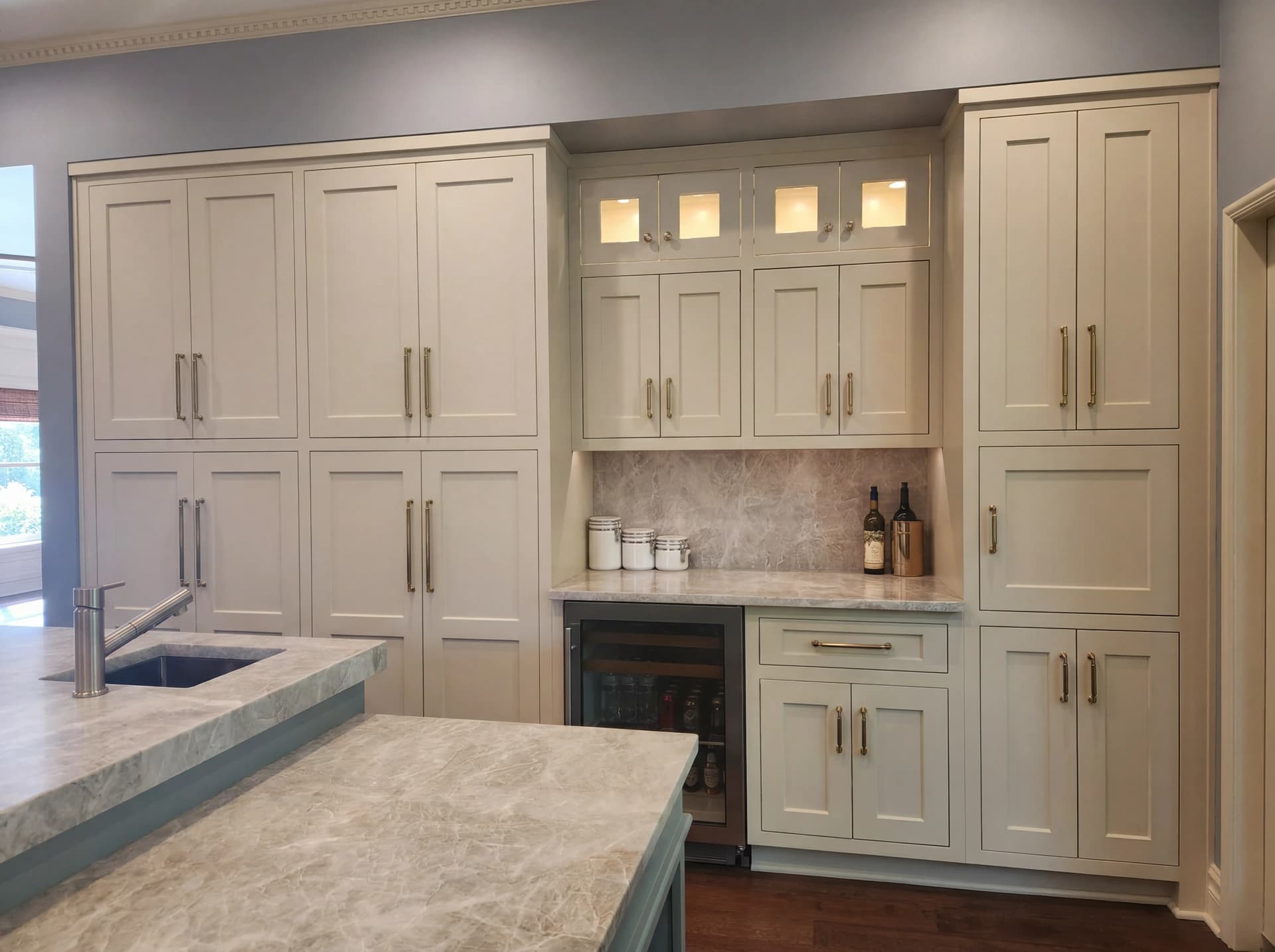 Large kitchen with light wood cabinets and a marble countertop.