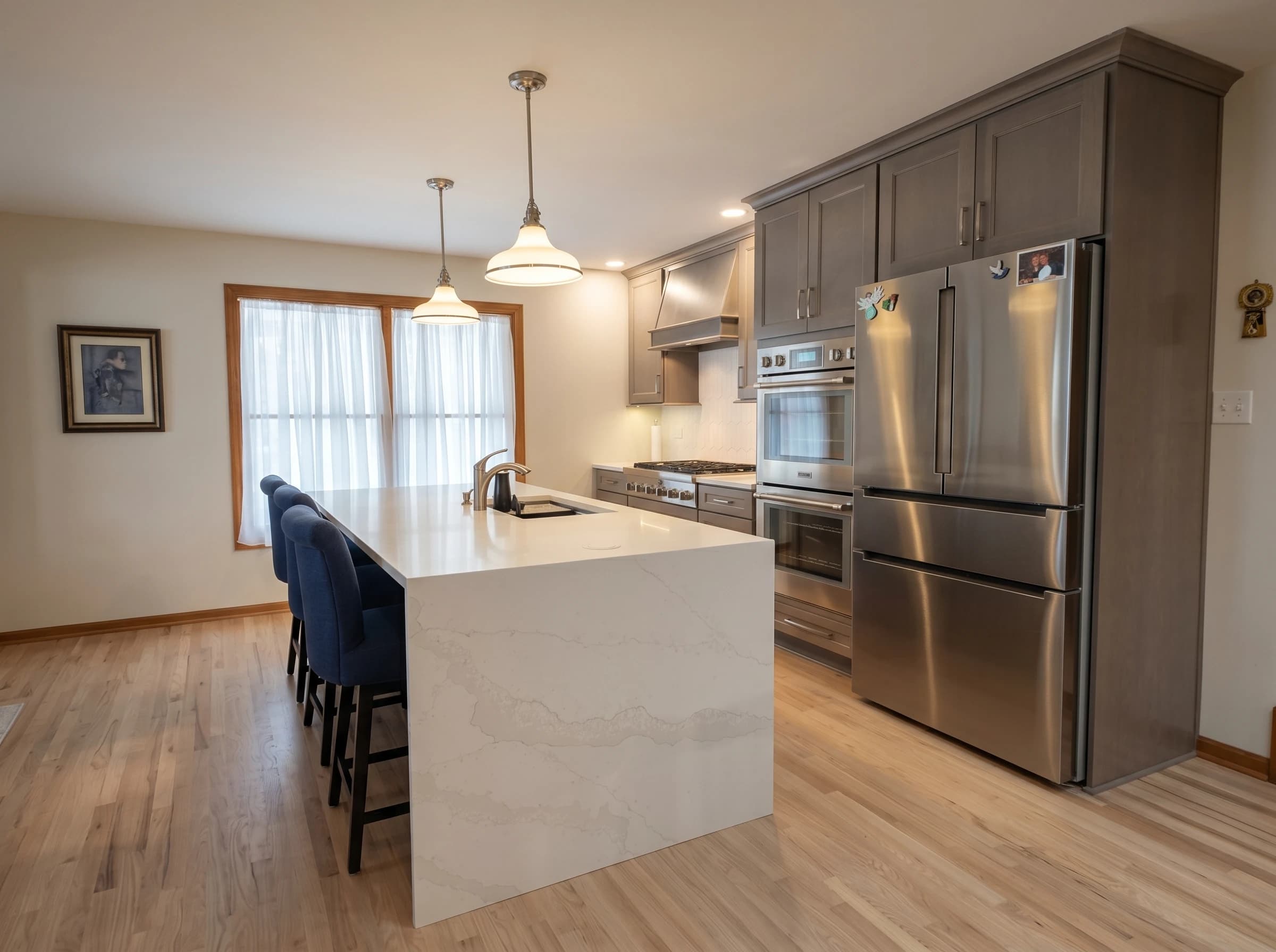 Kitchen remodeled with modern appliances, granite countertops, and blue cabinets.